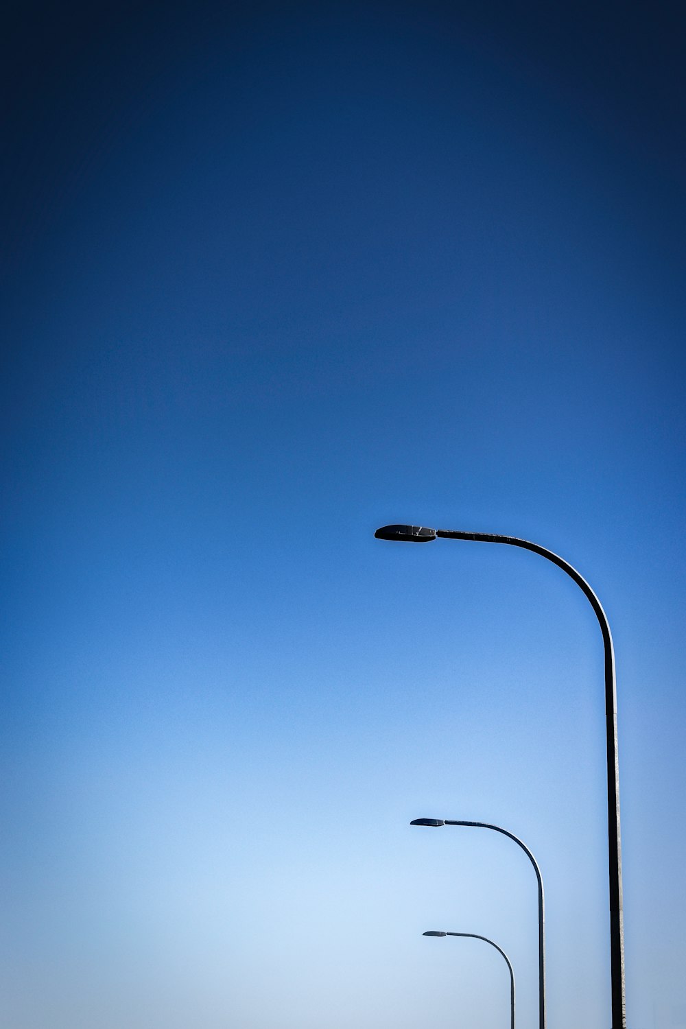 a couple of street lights sitting on the side of a road