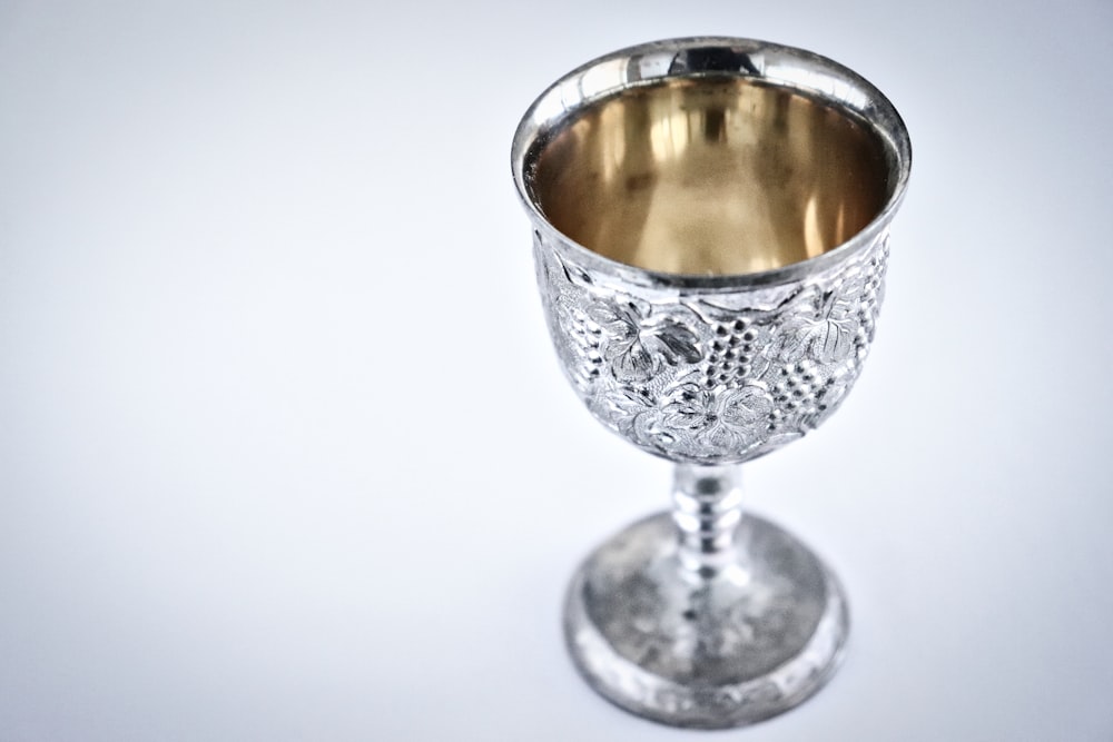 a silver cup sitting on top of a table