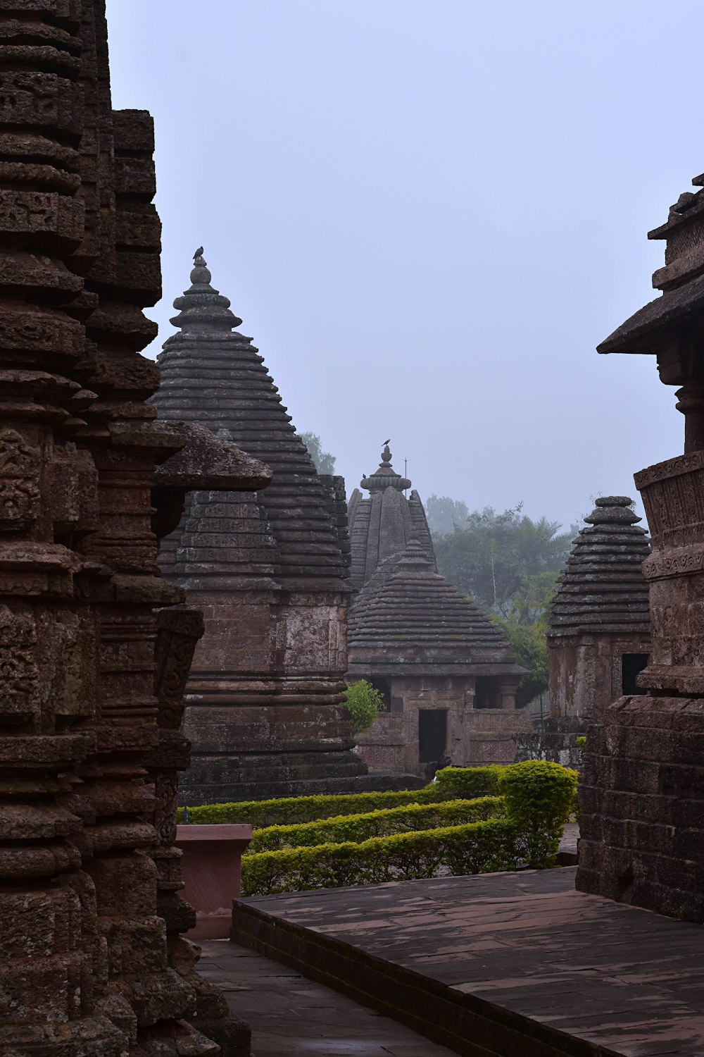 a row of stone buildings with a clock tower in the background