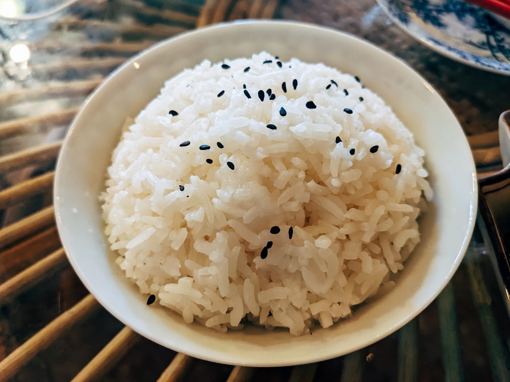 a bowl of white rice with black sesame seeds