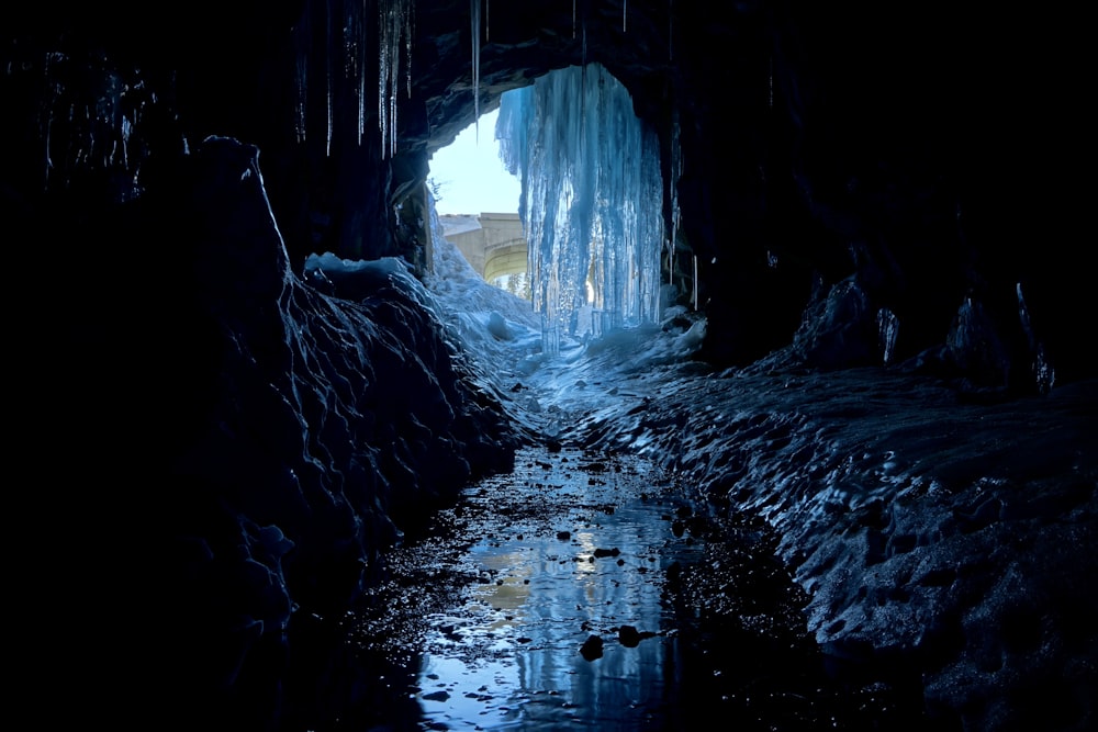 a dark tunnel with ice hanging from it's sides