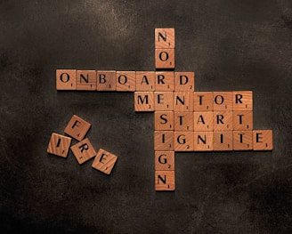 a scrabble of words that say no on board, mentor, start,
