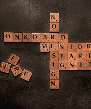 a scrabble of words that say no on board, mentor, start,