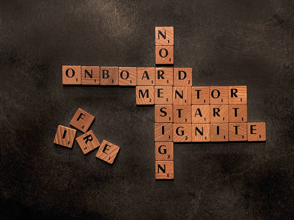 a scrabble of words that say no on board, mentor, start,