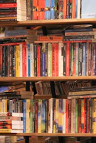 A colorful selection of popular books stacked on a shelf.