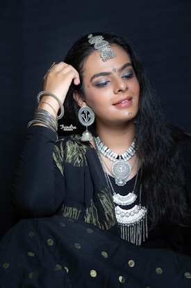 a woman wearing a black outfit and jewelry