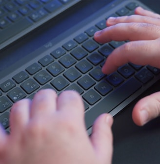 a person typing on a computer keyboard