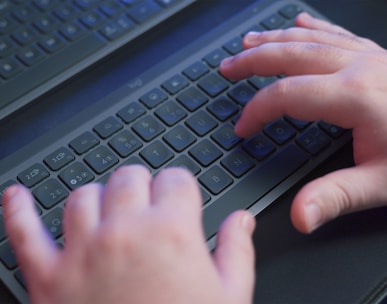 a person typing on a computer keyboard