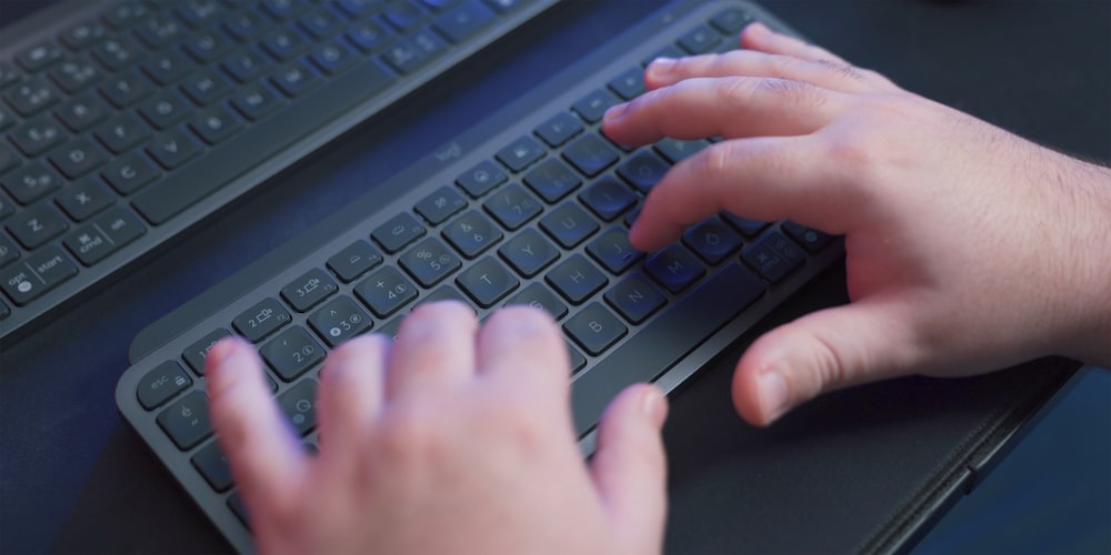 a person typing on a computer keyboard