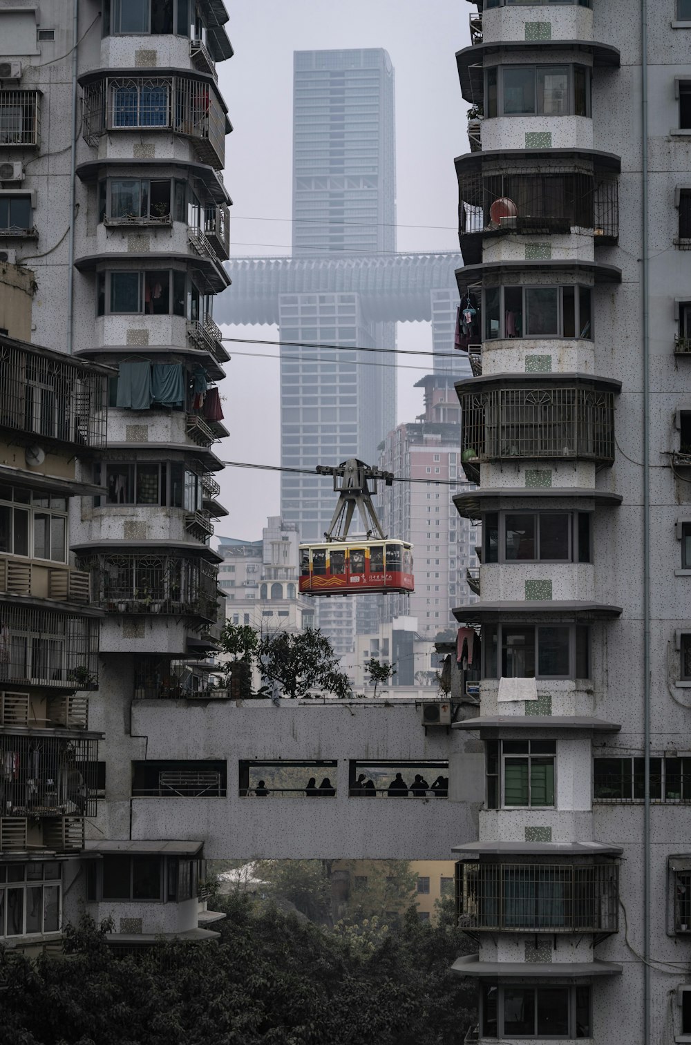 a cable car going through a city with tall buildings