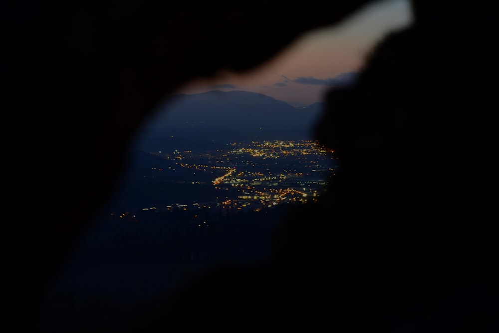 a view of a city from a hill at night