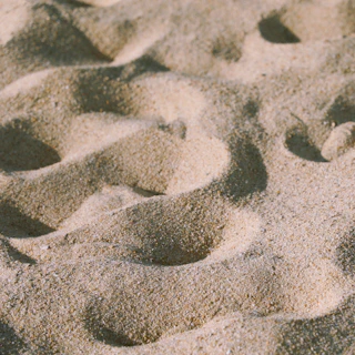 footprints in the sand of a sandy beach