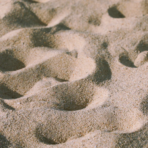 footprints in the sand of a sandy beach
