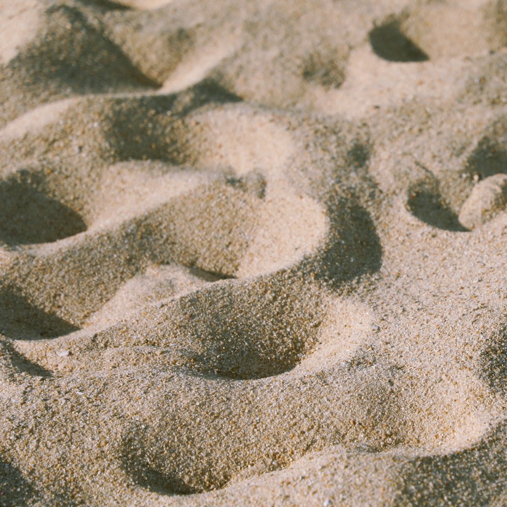 footprints in the sand of a sandy beach