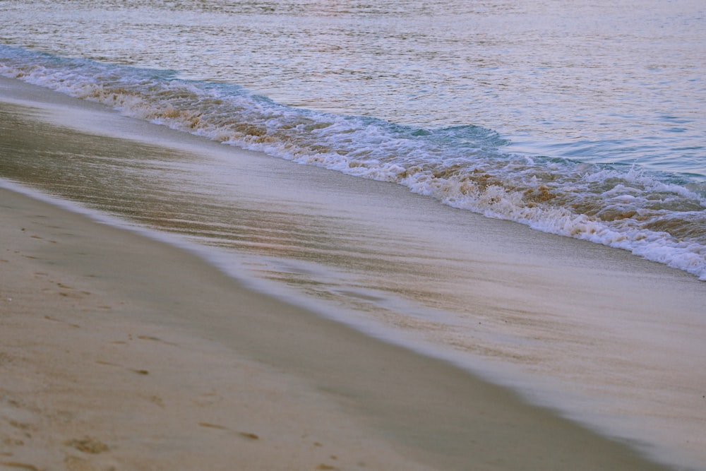 a beach with waves coming in to shore