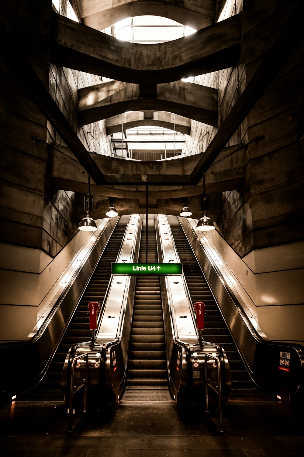 two escalators in a large building with a skylight