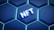 A digital graphic featuring a series of glowing hexagons with a modern, sleek design. In the center, the acronym 'NFT' is prominently displayed, illuminated in a 3D style.
