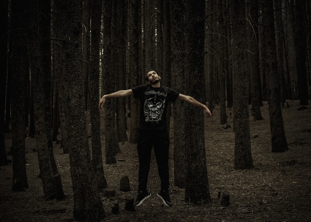 a man standing in the middle of a forest