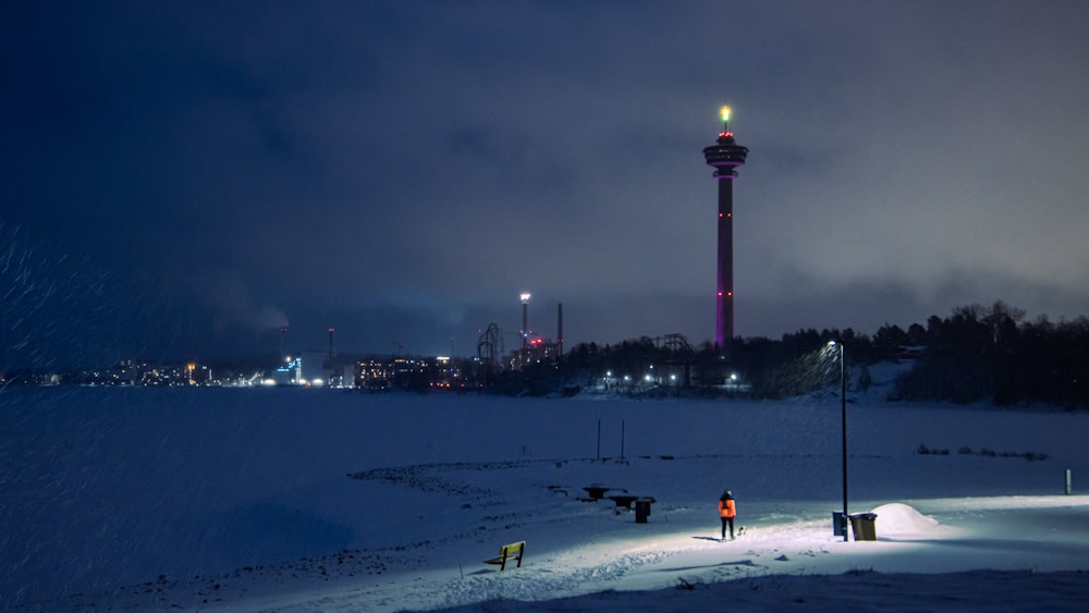 a couple of people standing on a snow covered field