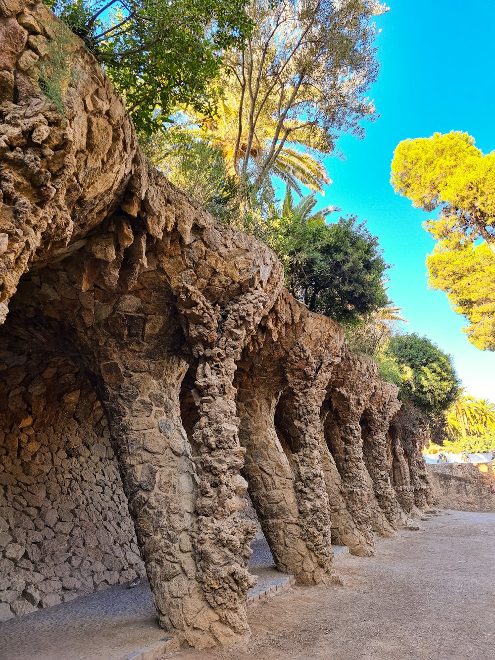 a row of rock formations next to a forest