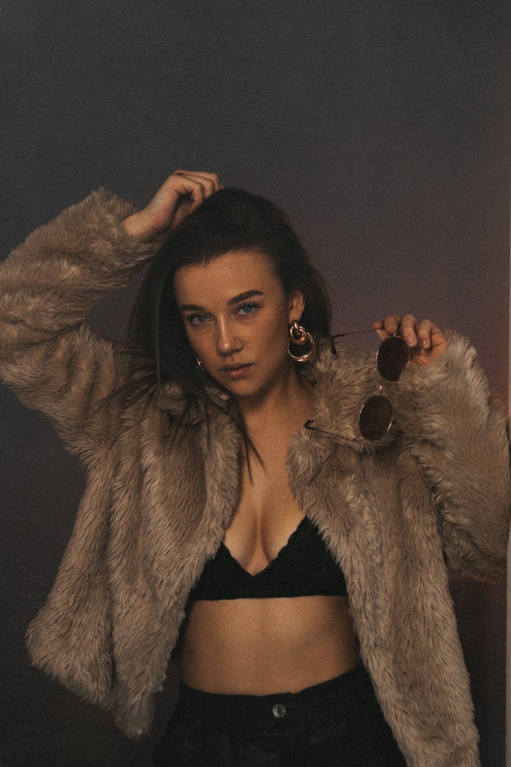 a woman in a crop top and fur coat