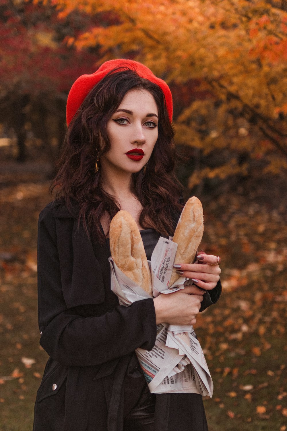a woman in a red hat holding a loaf of bread