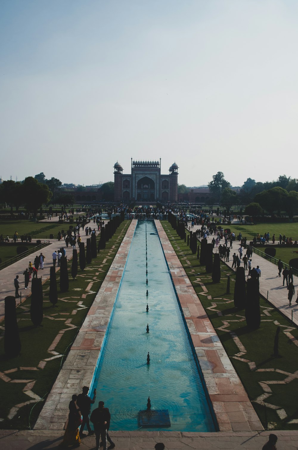 a long pool in the middle of a park