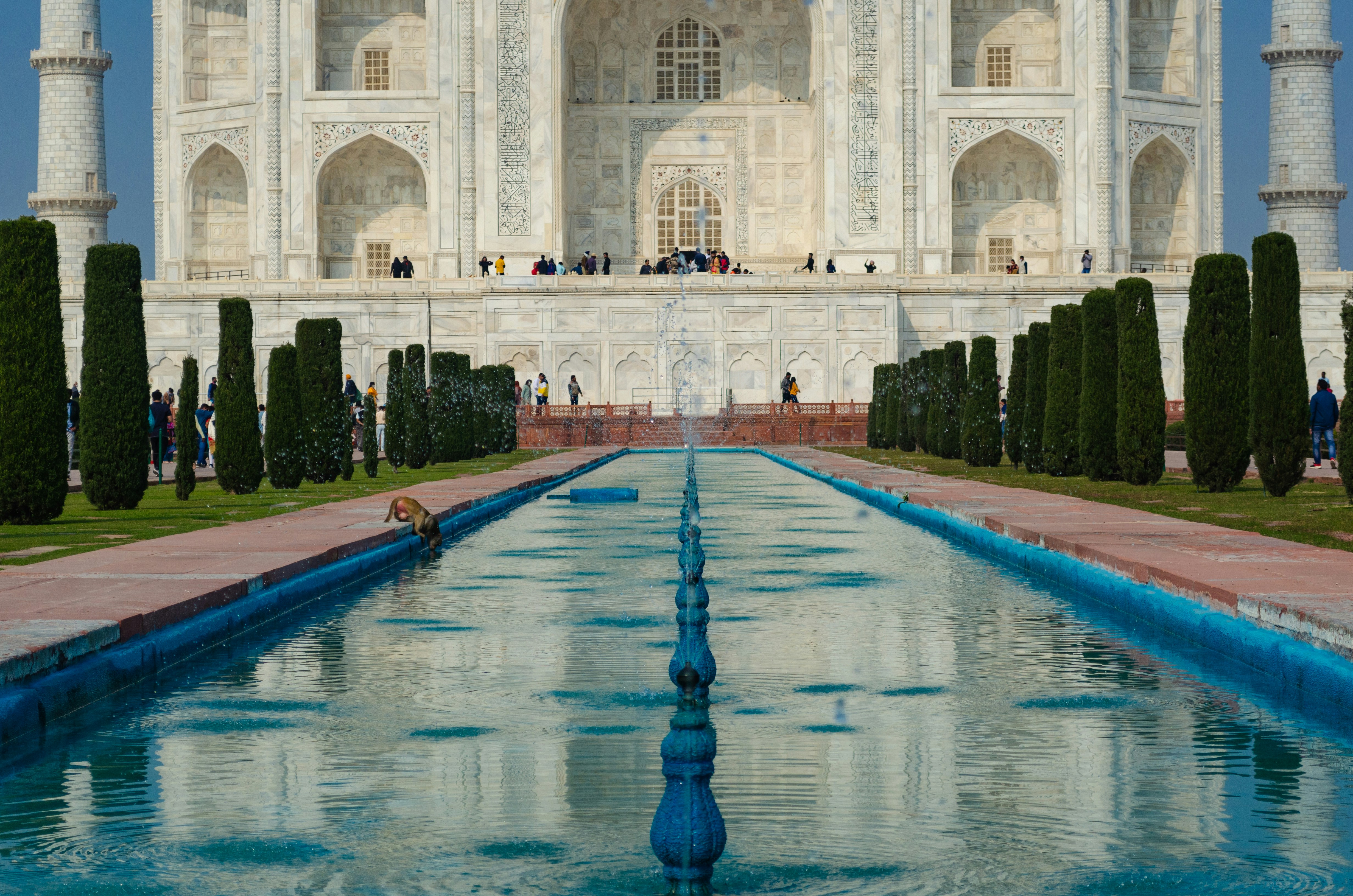 a large white building with a fountain in front of it