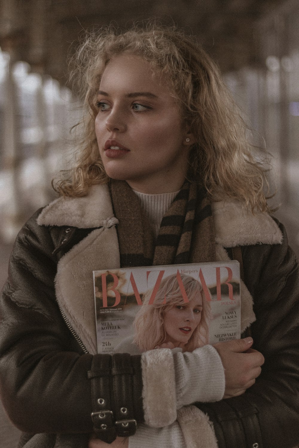 a woman holding a magazine in her hands