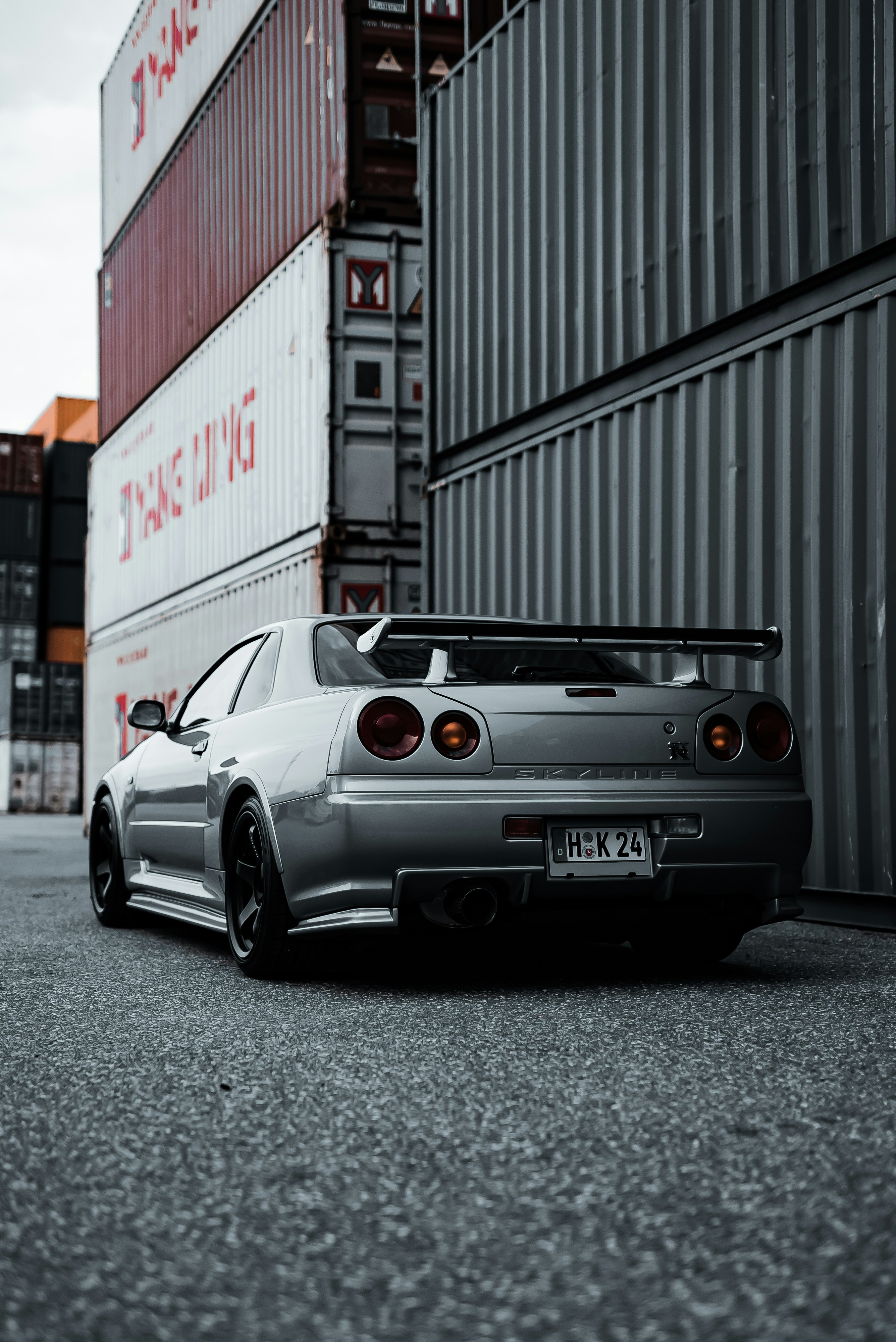 a car parked in front of a shipping container