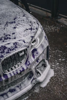 the front of a car covered in snow