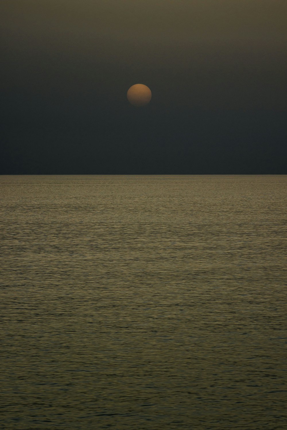 a large body of water under a cloudy sky