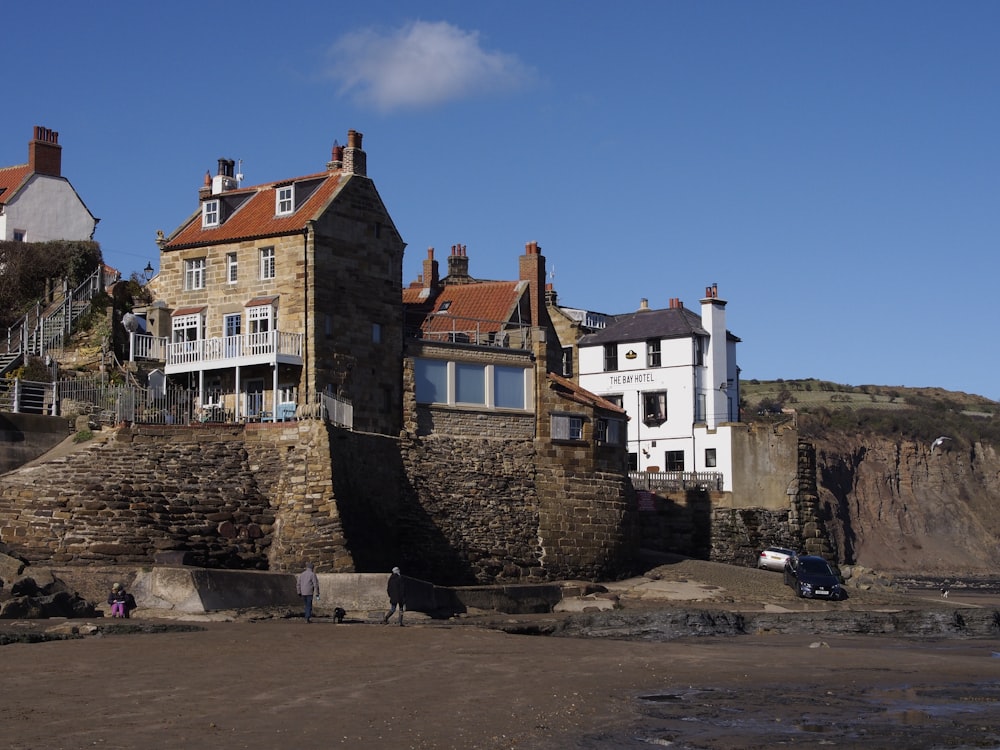 a group of buildings sitting on top of a sandy beach