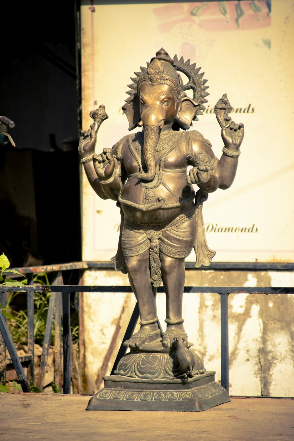 a statue of an elephant god in front of a building