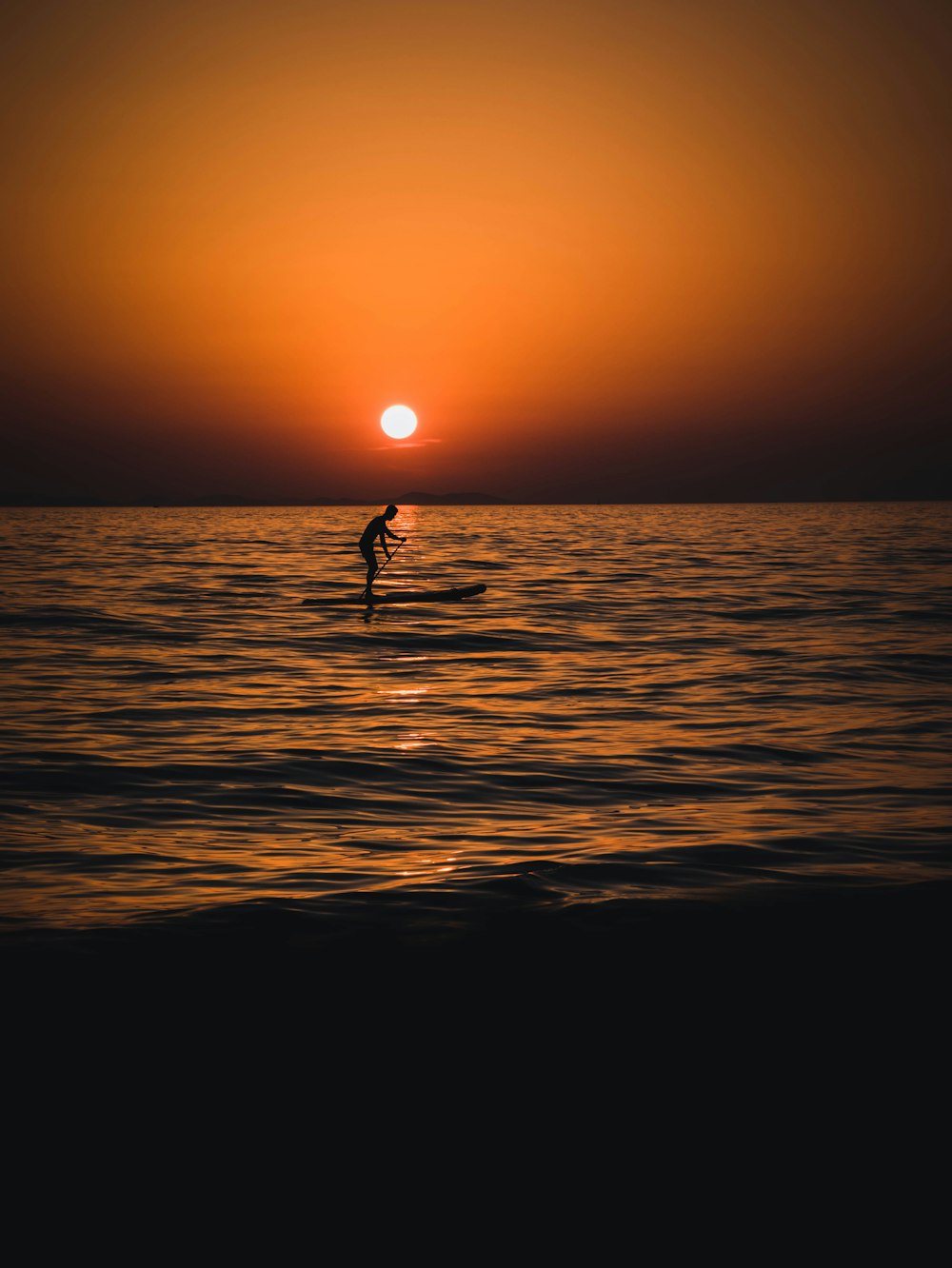 a person riding a surfboard on a body of water