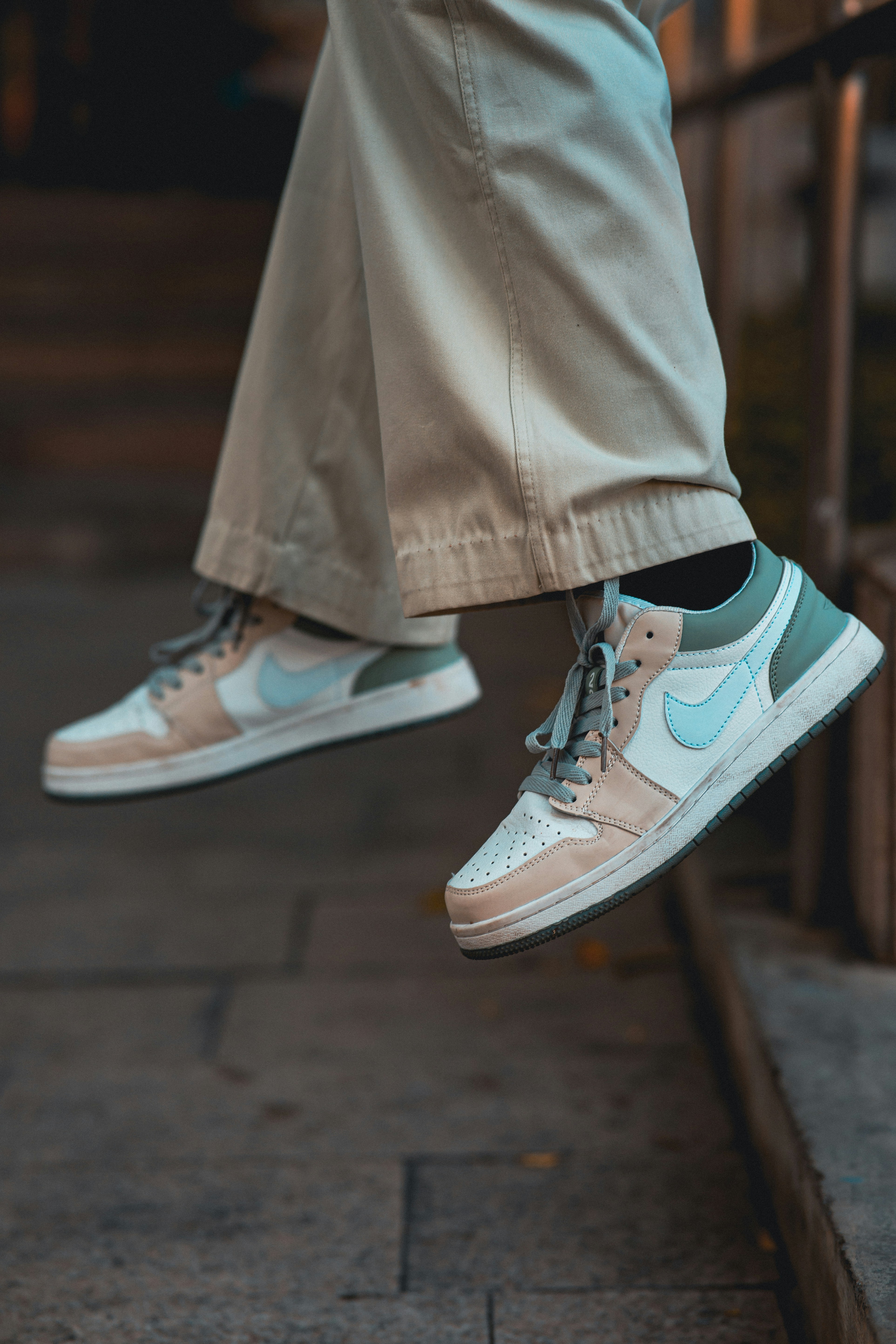 a person standing on a ledge with their feet in the air