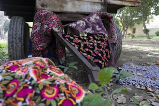 Handwoven decorative handcarts displayed with vibrant traditional fabrics