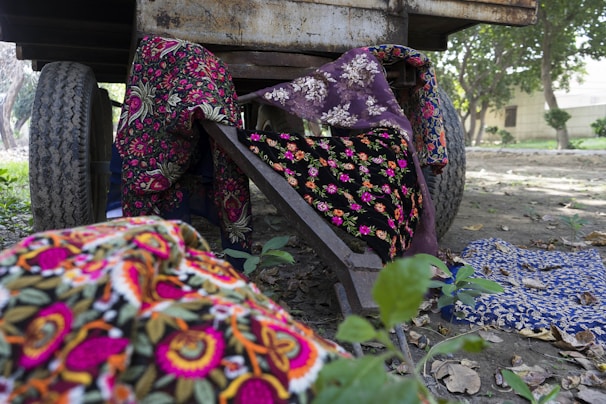 Handwoven decorative handcarts displayed with vibrant traditional fabrics