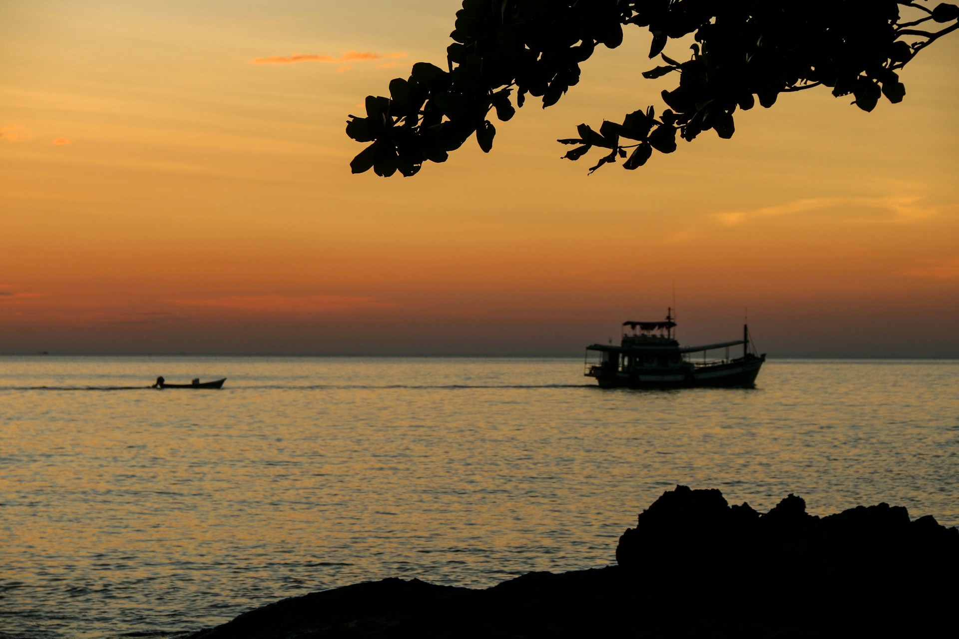 a boat is in the water at sunset