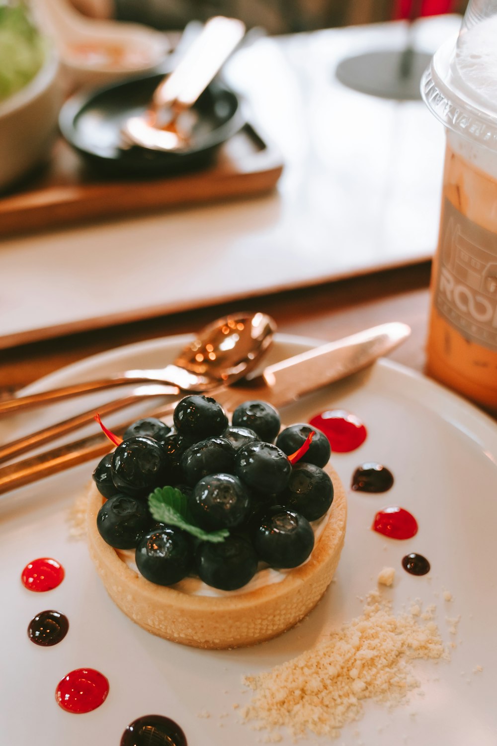 a plate with a pastry topped with blueberries