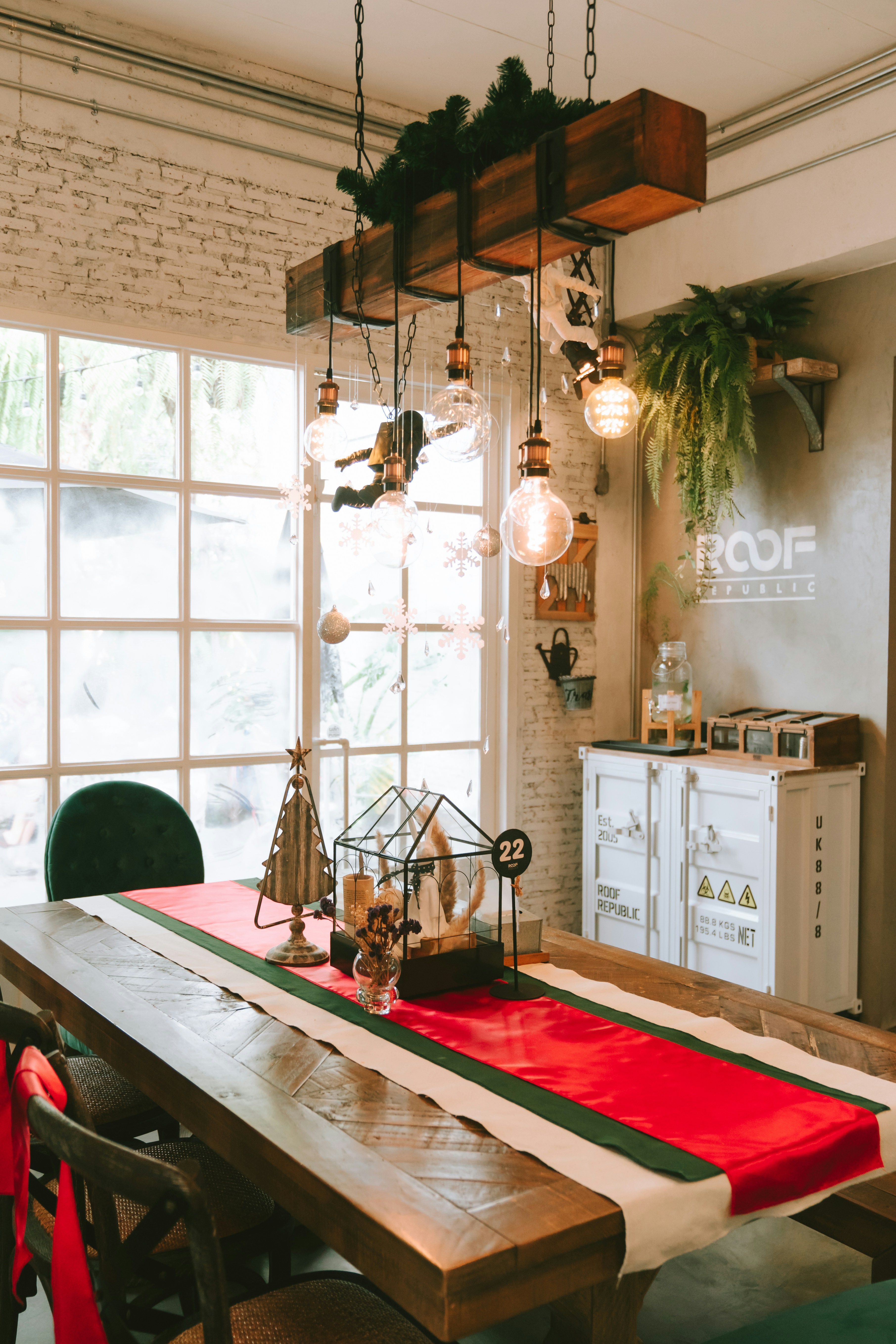 a dining room table with a red and green table runner