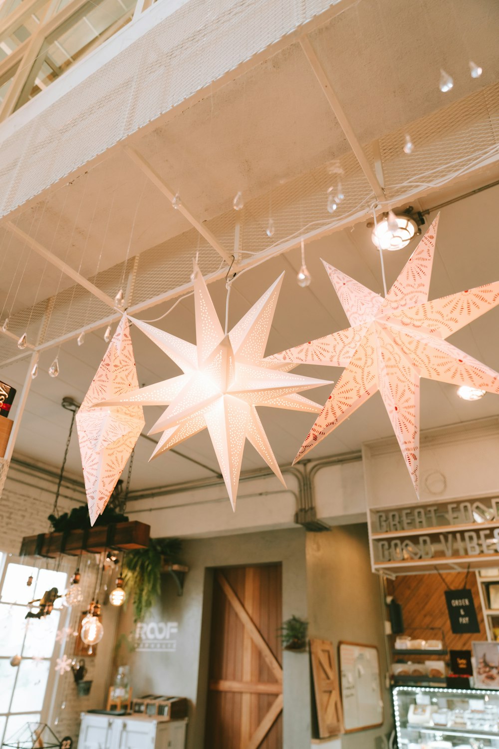 a group of paper stars hanging from a ceiling