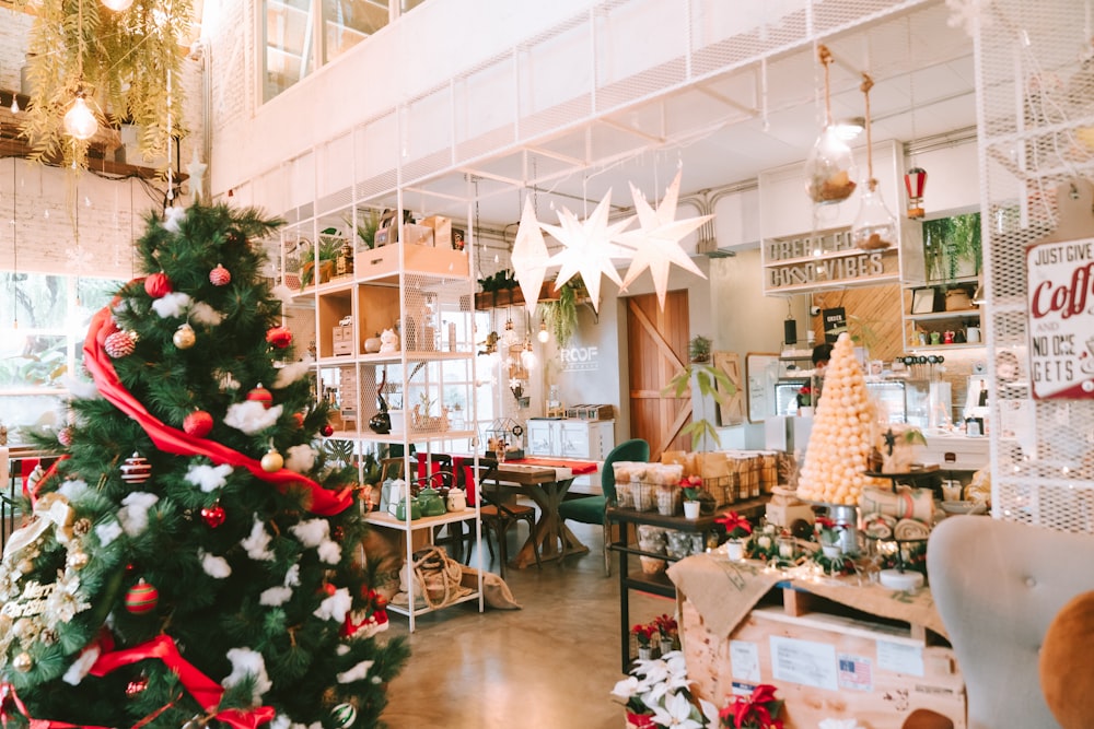 a decorated christmas tree inside of a store