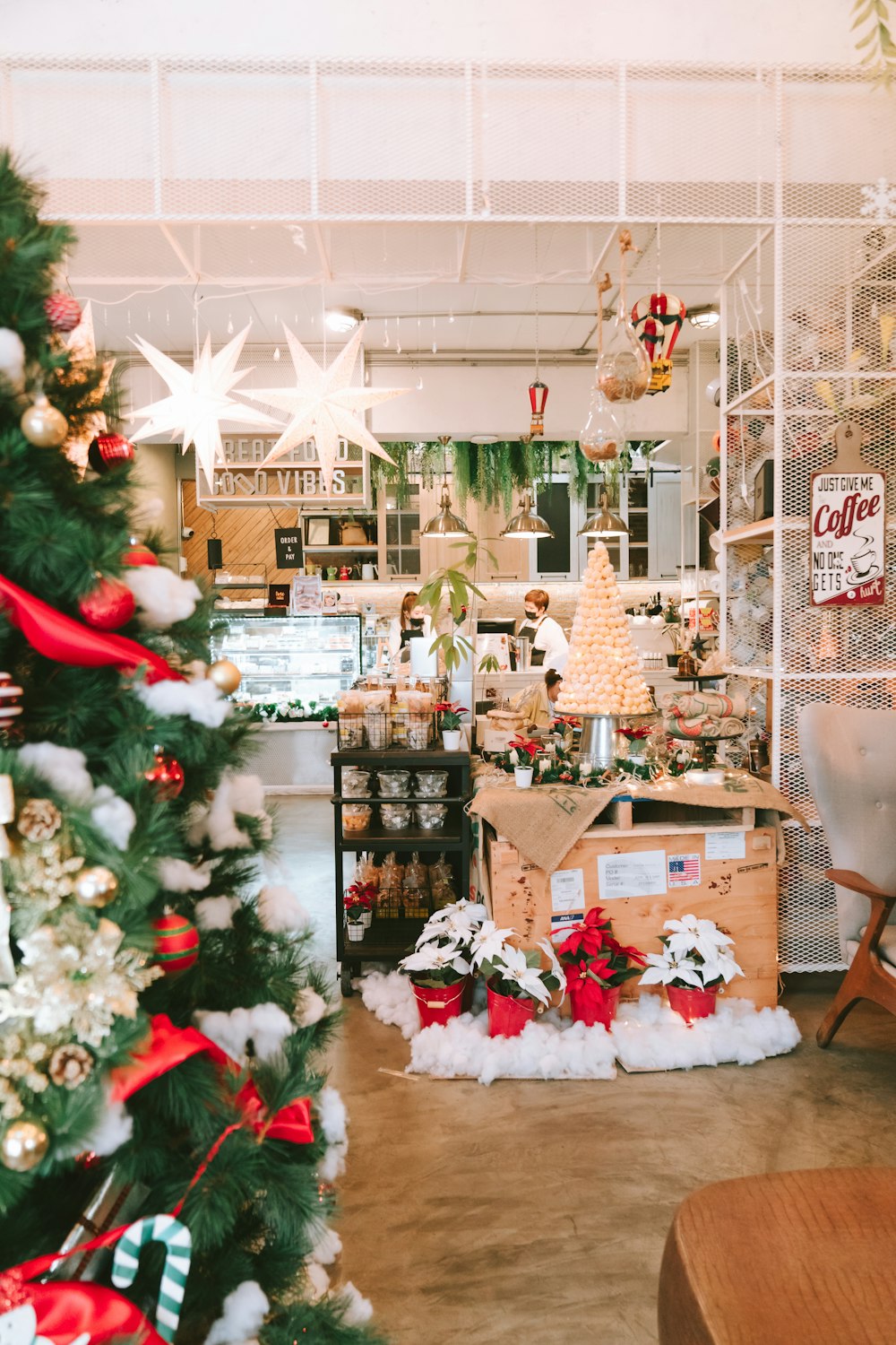 a christmas tree in a store filled with lots of decorations