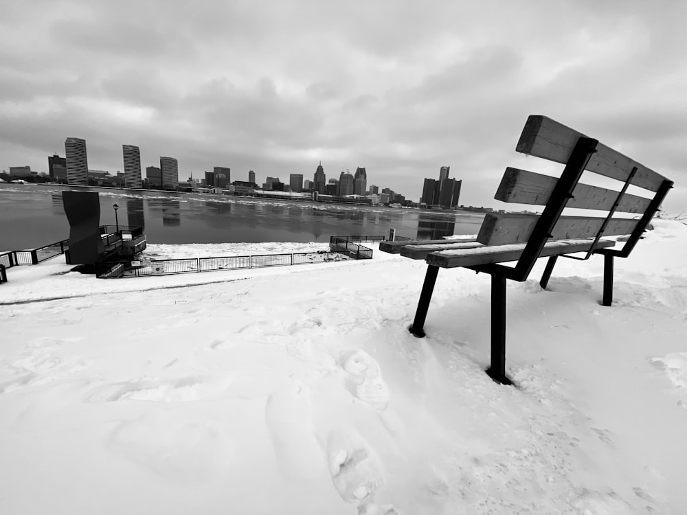 a couple of benches sitting on top of snow covered ground