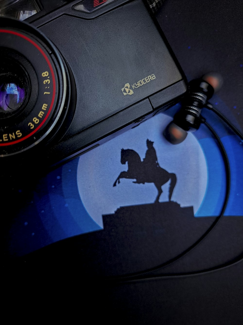 a camera with a picture of a man riding a horse
