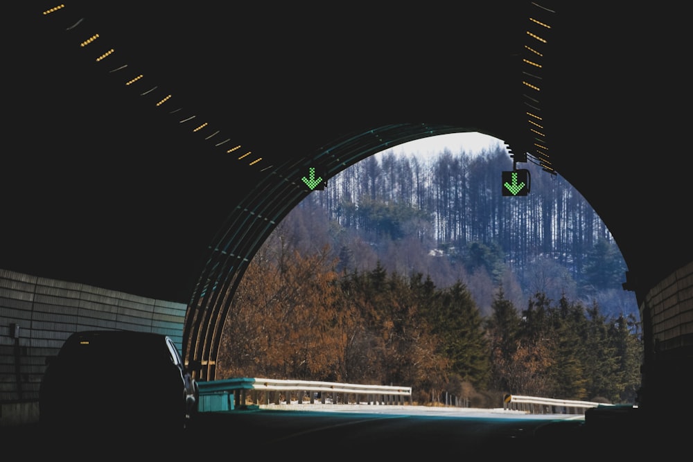 a tunnel with a view of a mountain through it