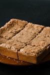 a piece of cake sitting on top of a wooden plate