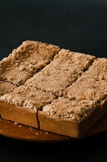 a piece of cake sitting on top of a wooden plate