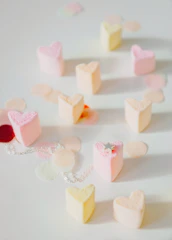 a white table topped with lots of small hearts